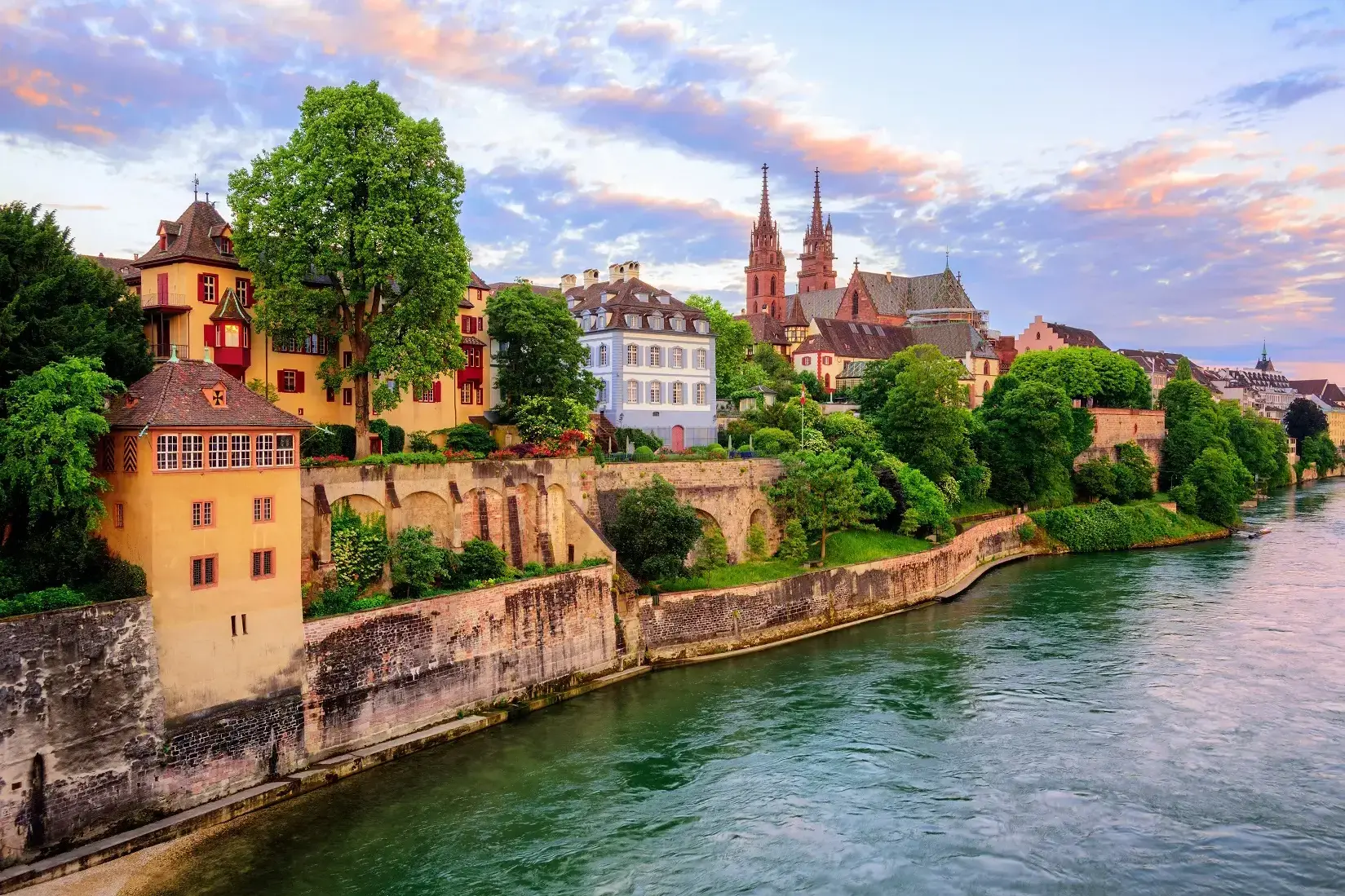 The_Old_Town_of_Basel_with_red_stone_Munster_cathedral_and_the_Rhine_river__Switzerland__in_dramatic_sunset_light_small.webp